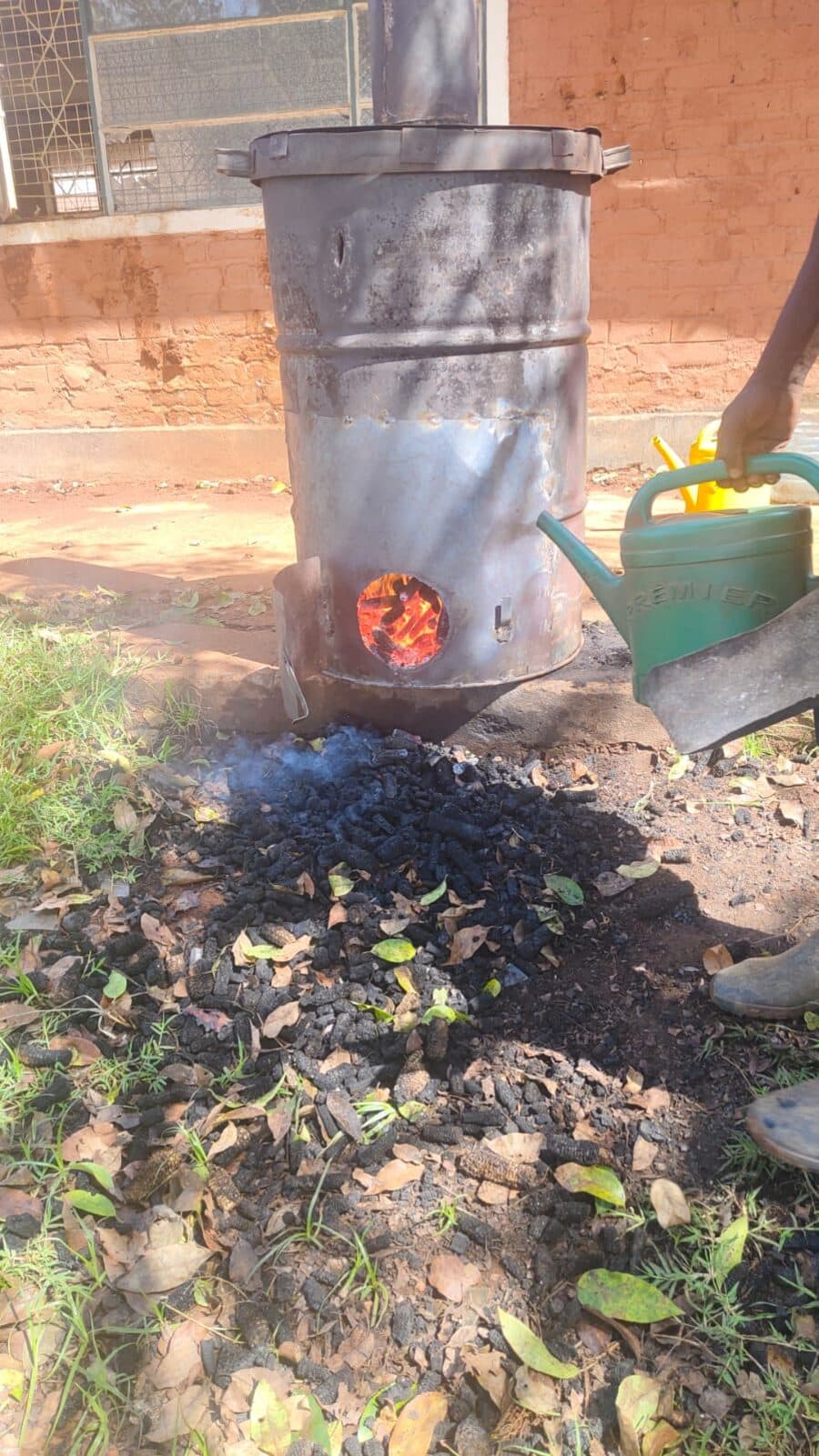 Quenching the char while embers still glow inside the kiln