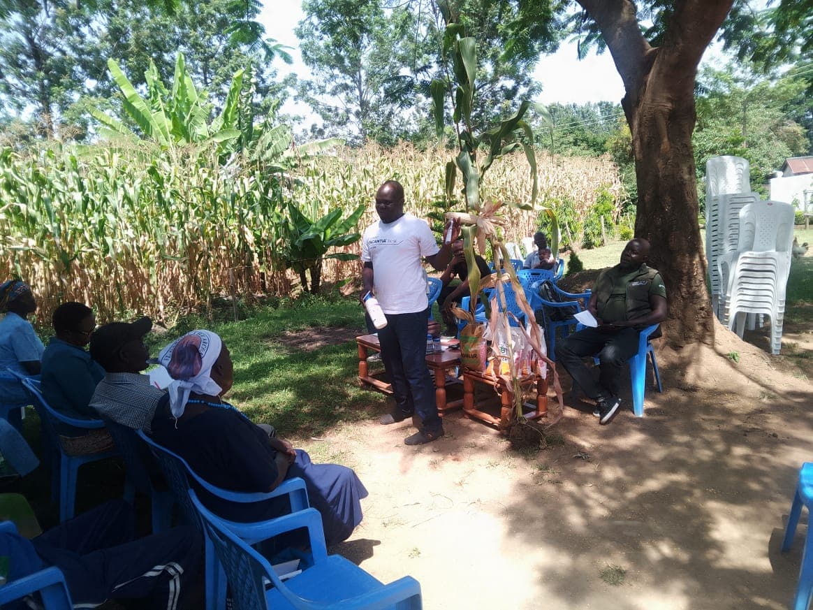 Farmer proudly showing his improved maize harvest after completing Ke Devries Farm training program